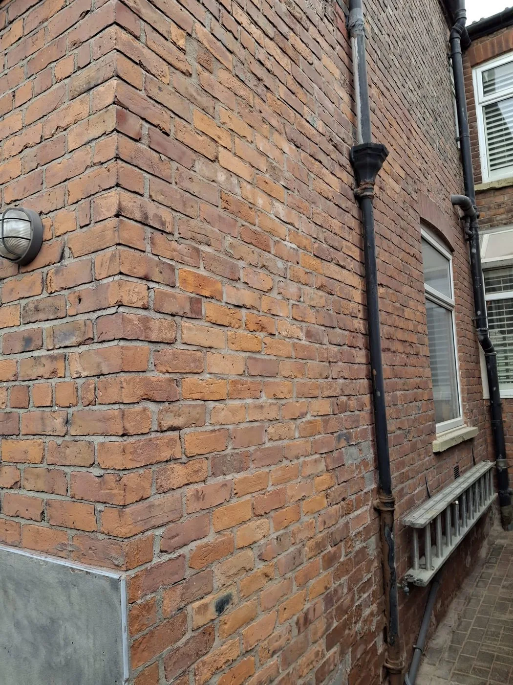 Cleaned and repointed Victorian brick surface retaining its original texture