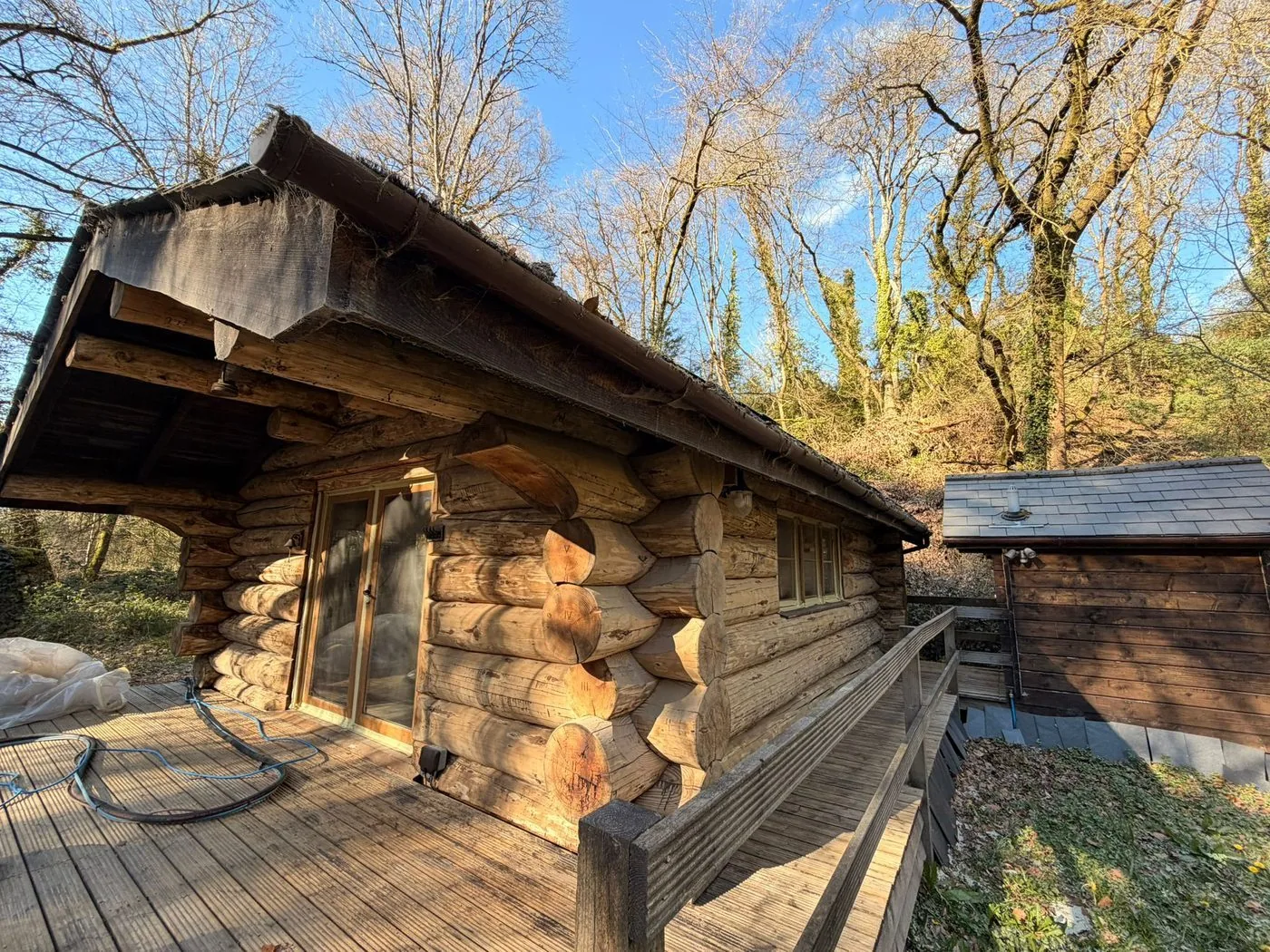 Cleaned cabin elevation displaying consistent warm timber tones across the restored log courses