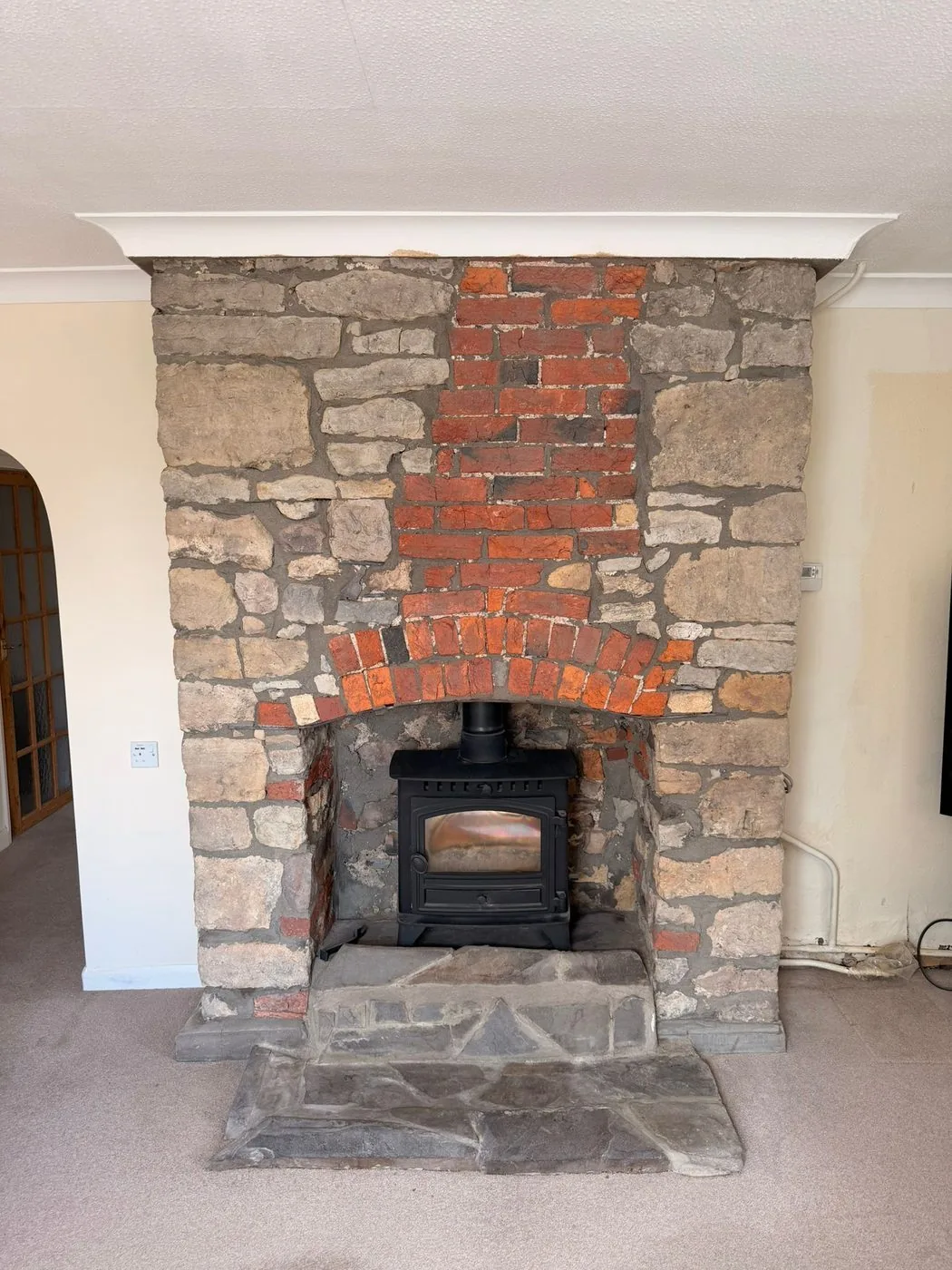 Cleaned stone surround and red brick arch with natural tones restored