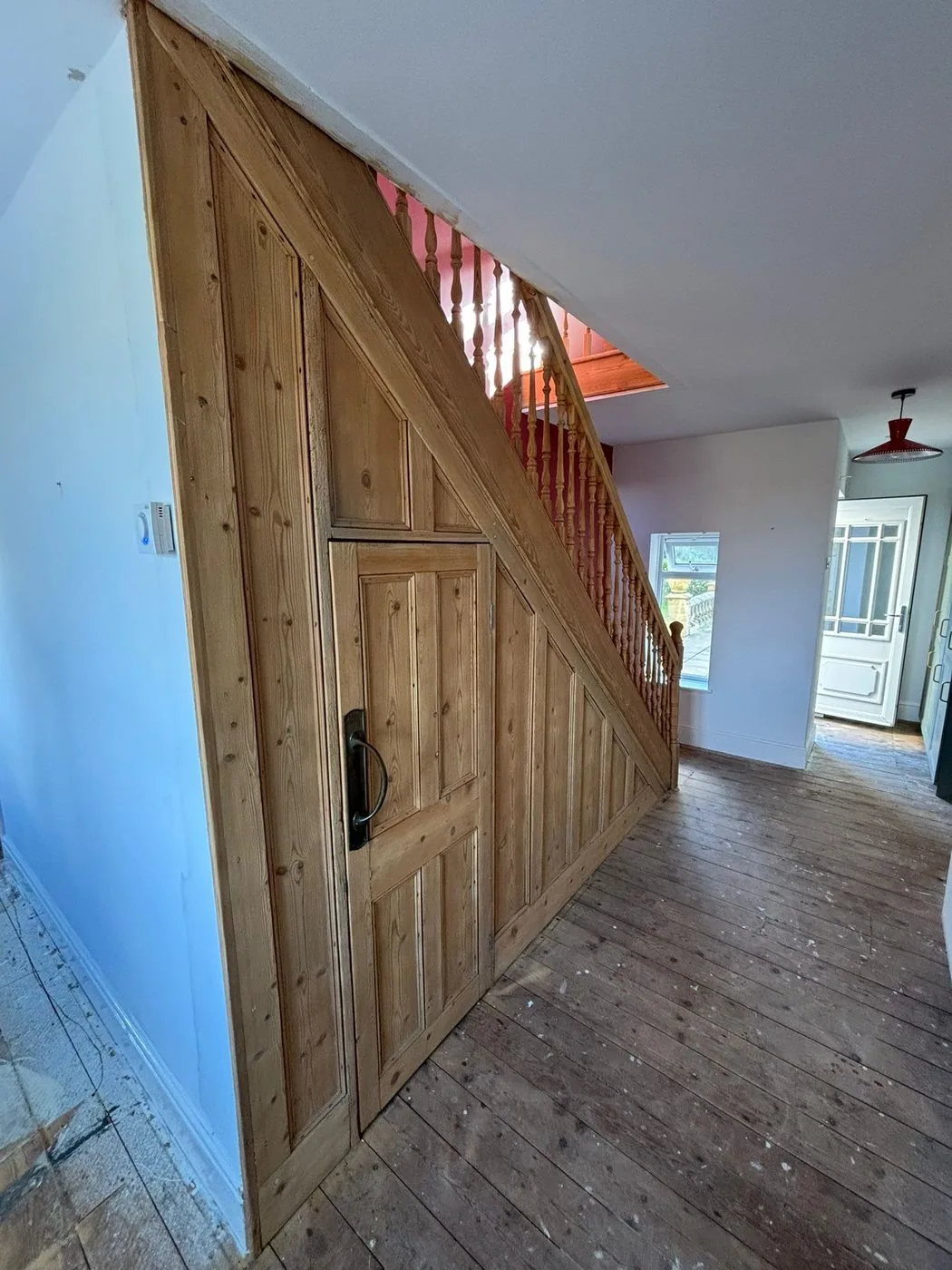 Restored pine staircase with cleaner grain and refreshed turned spindles after gentle preparation