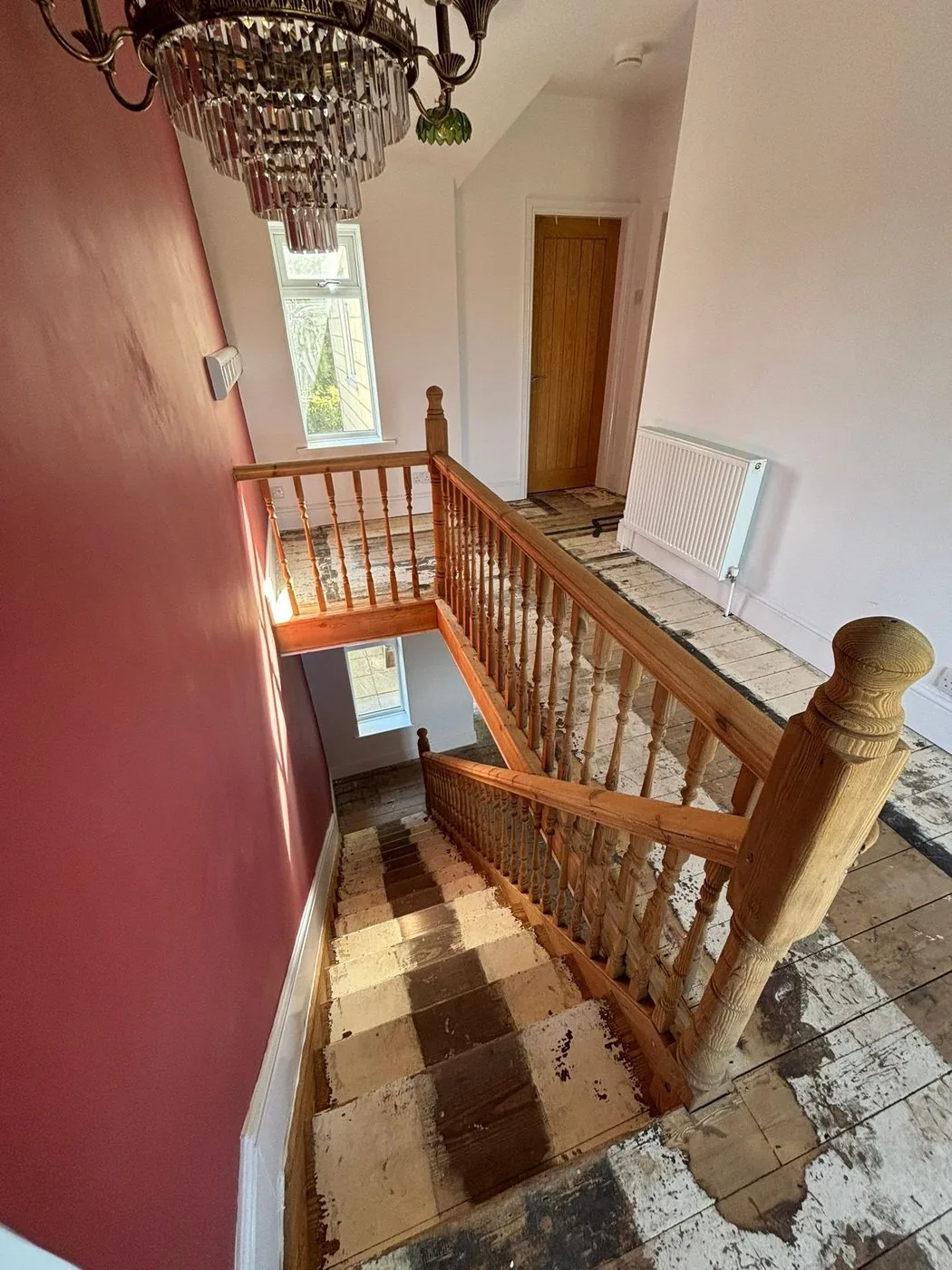 Clean under-stair pine panelling after controlled varnish removal, ready for protective finishing