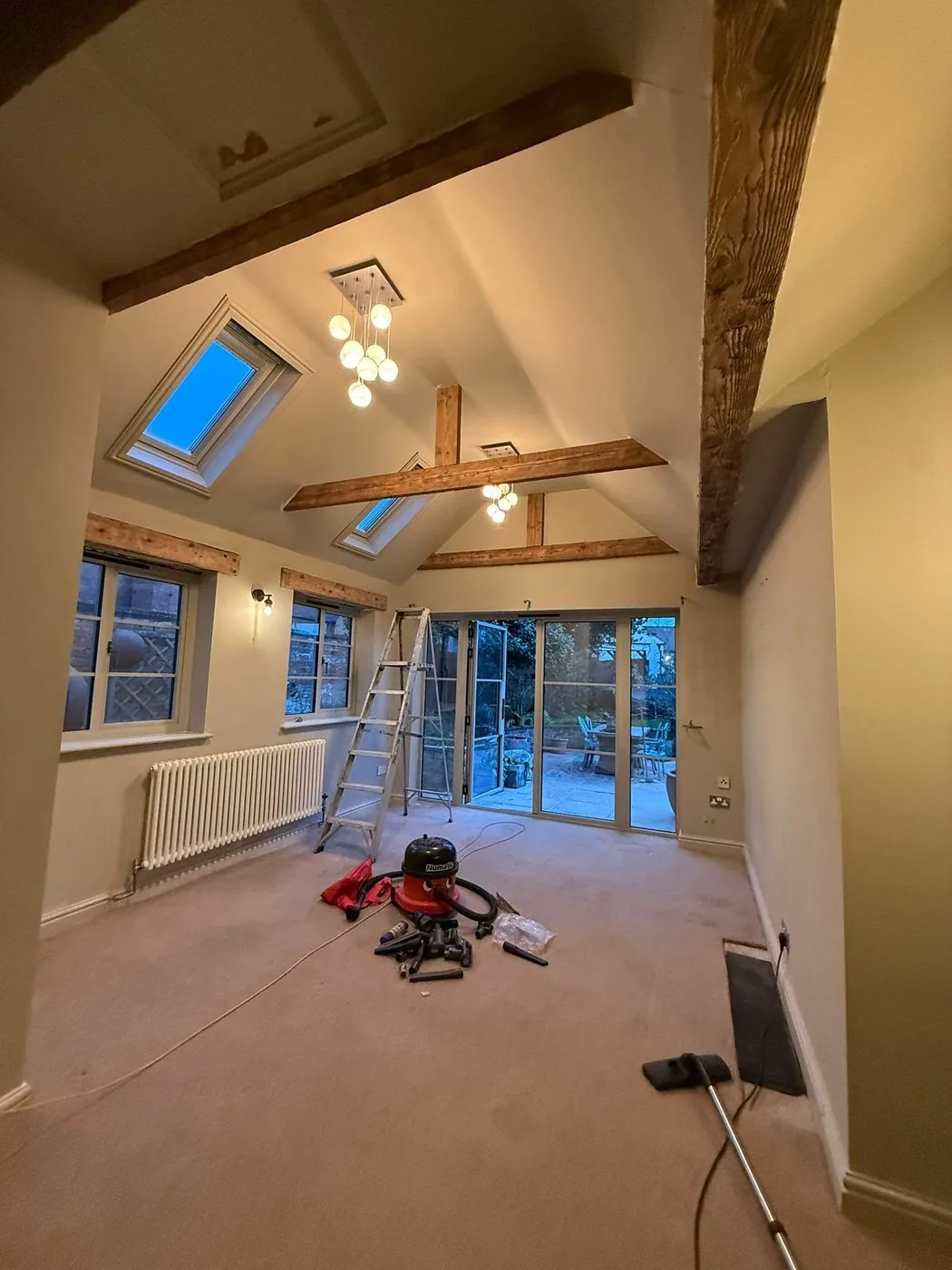 Naturally toned oak ceiling beams after coating removal