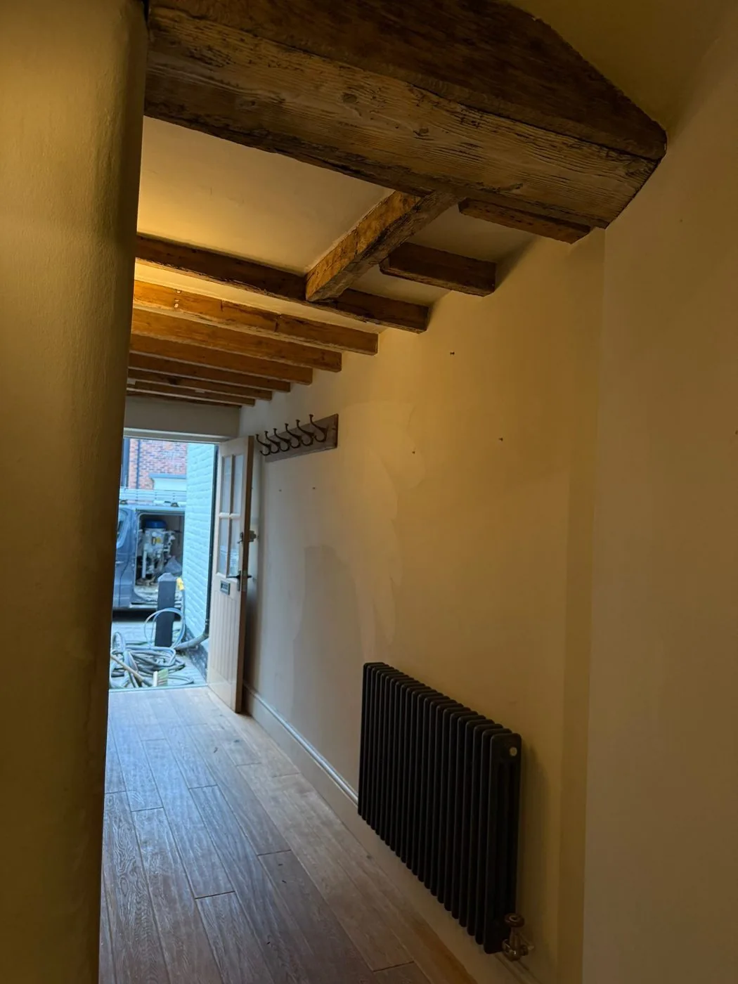 Clean period oak beams complementing lime plastered interior