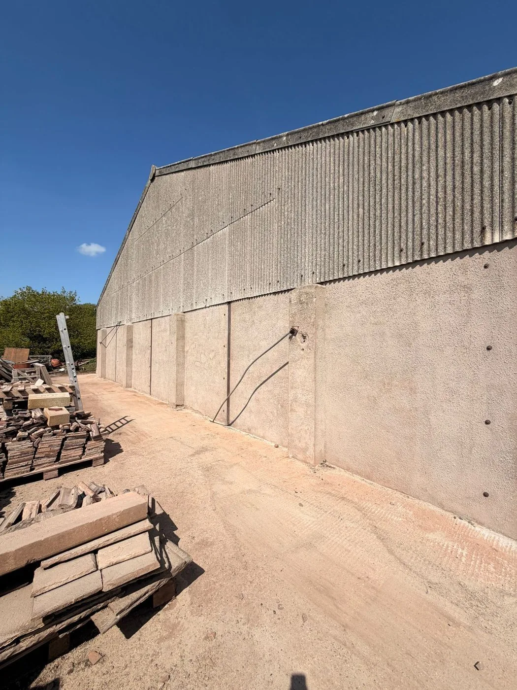 Agricultural barn wall and corrugated roof with a brighter, cleaner finish after gentle restoration