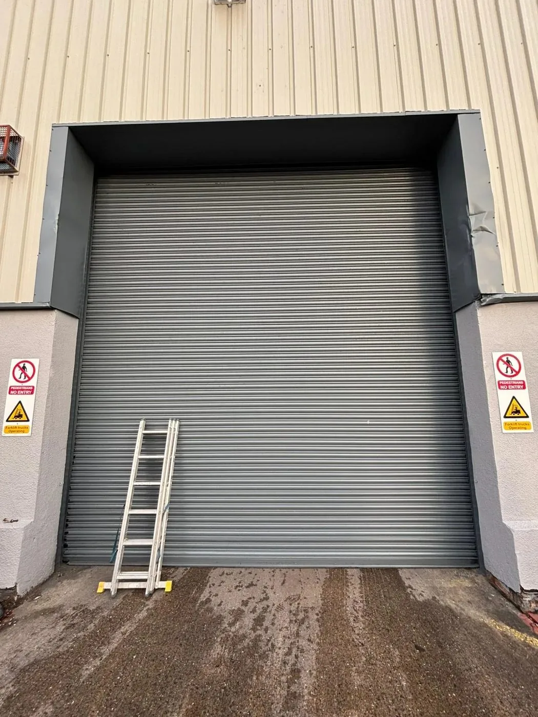 Restored steel roller shutter with a cleaner, more even surface ready for protective finishing