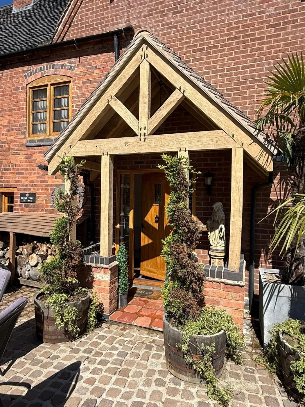 Restored oak porch frame with a cleaner, fresher surface and naturally visible timber grain