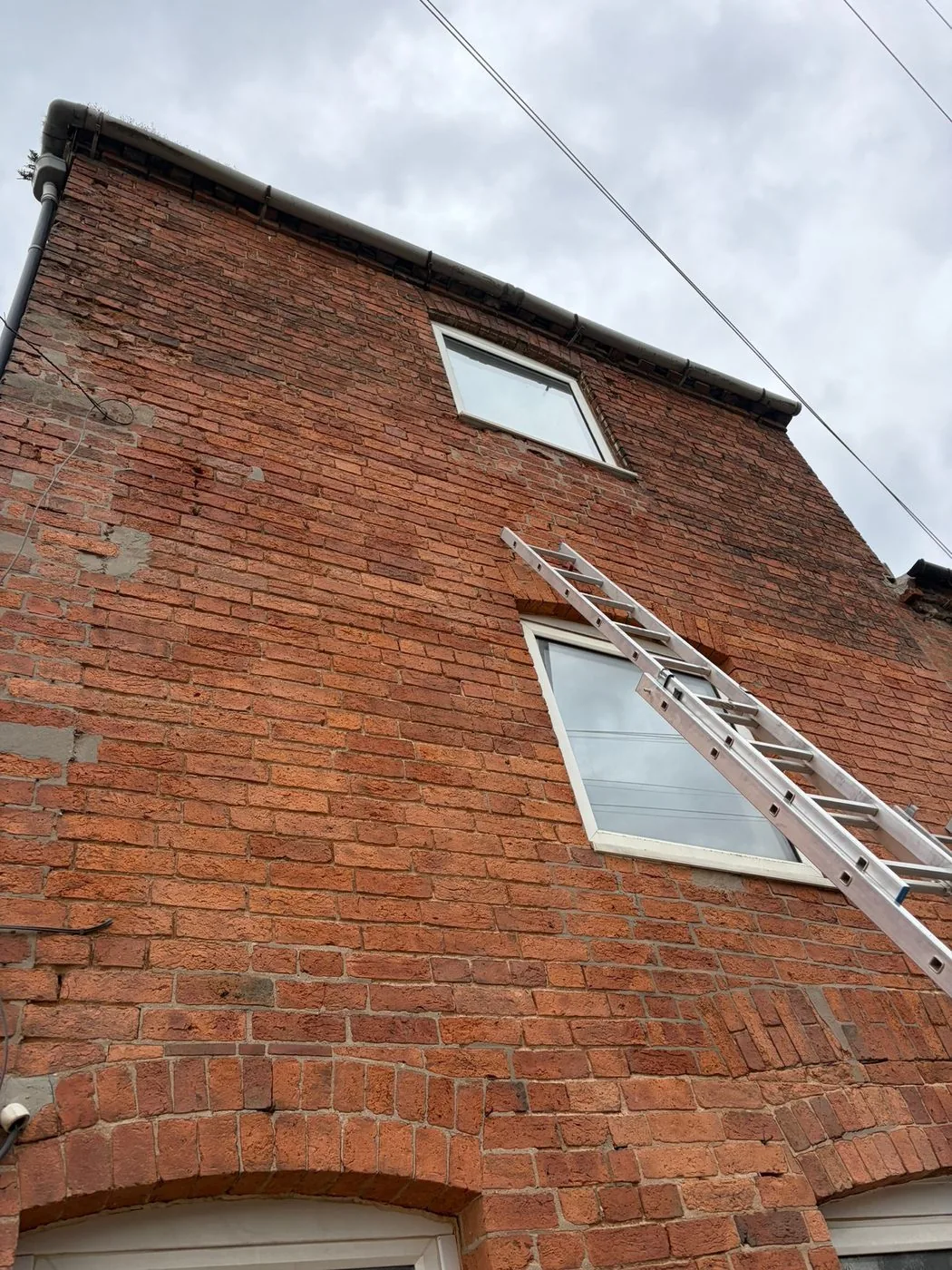 Residential red-brick facade showing restored colour and natural masonry texture