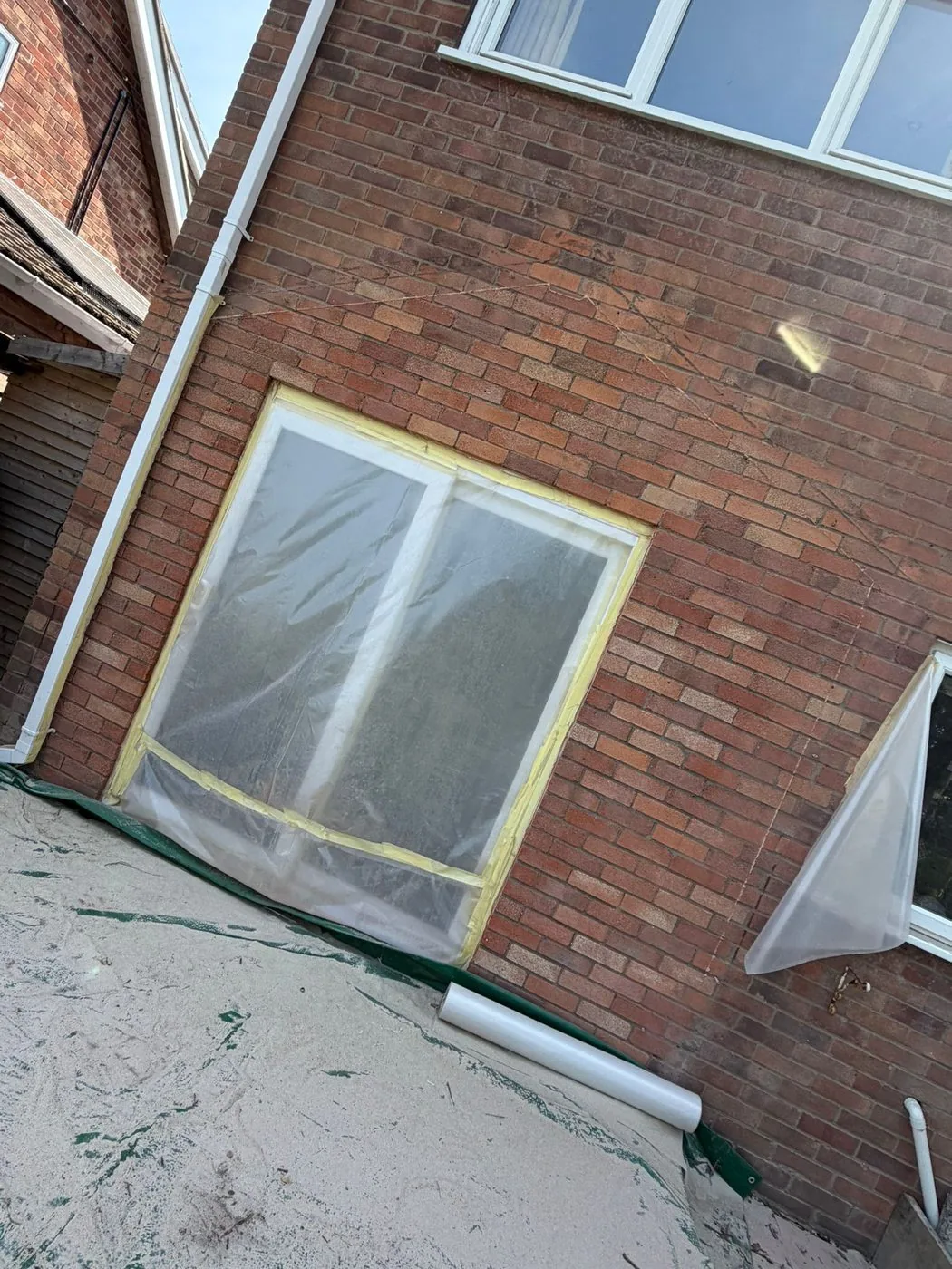 Cleaned gable brickwork with reduced staining and mortar marks, blending more closely with the original wall