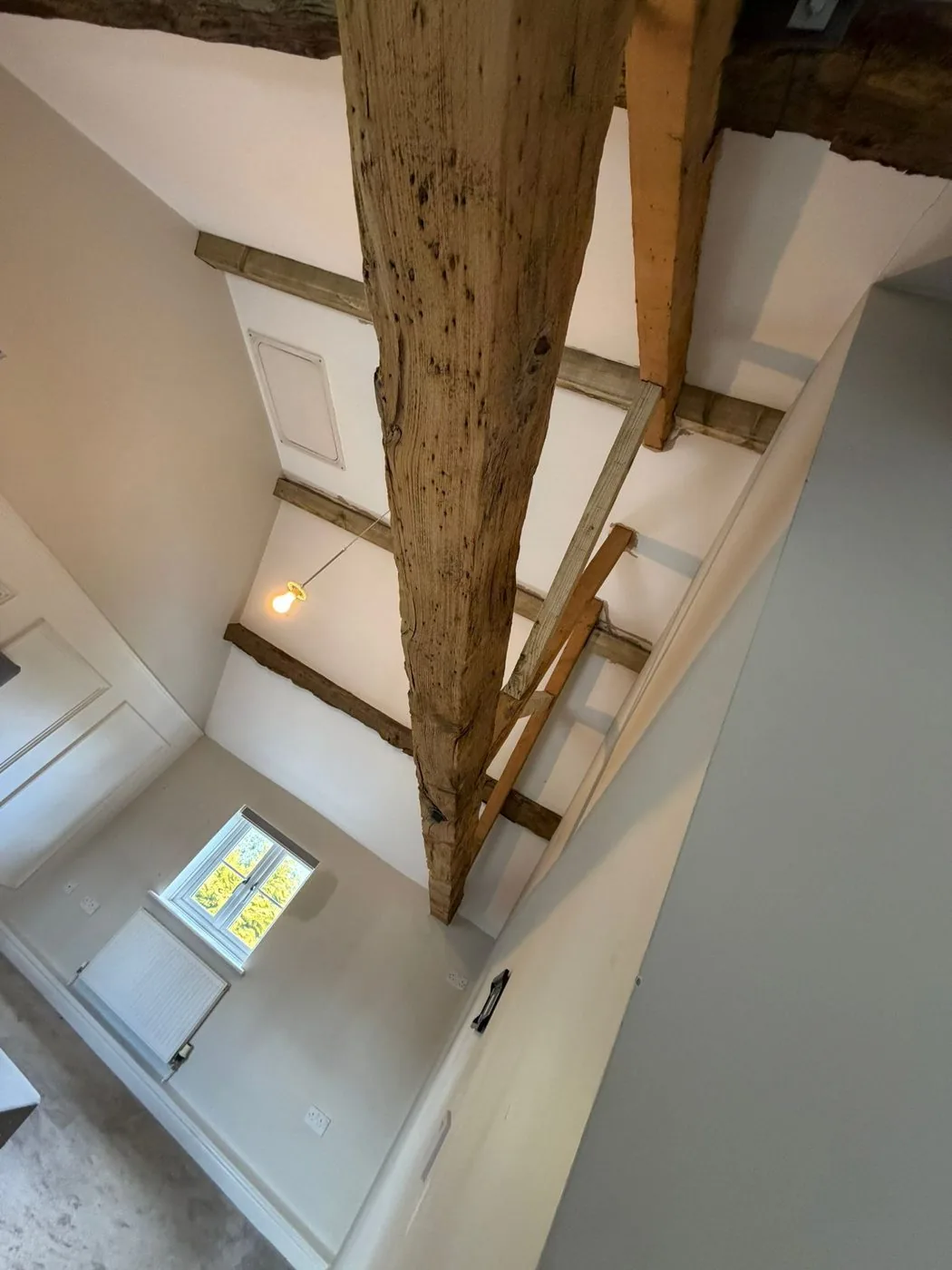 Cleaned interior timber beam with a brighter, more even surface and clearly visible natural wood grain