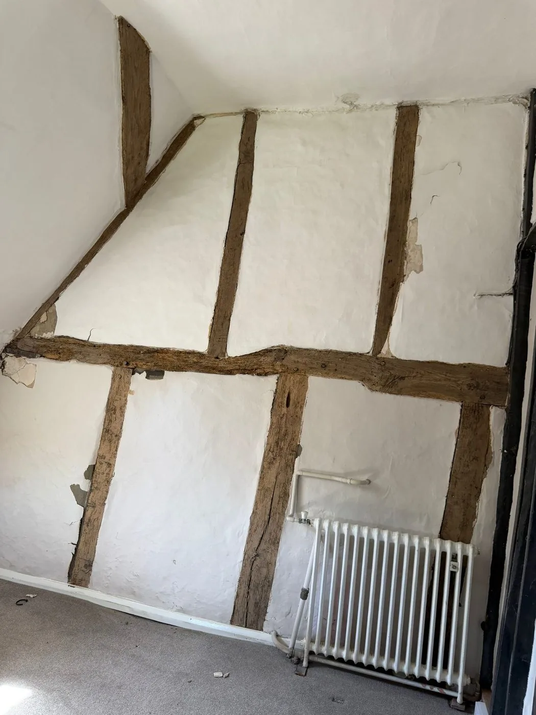 Restored oak beam showing clean natural timber and visible grain after paint removal