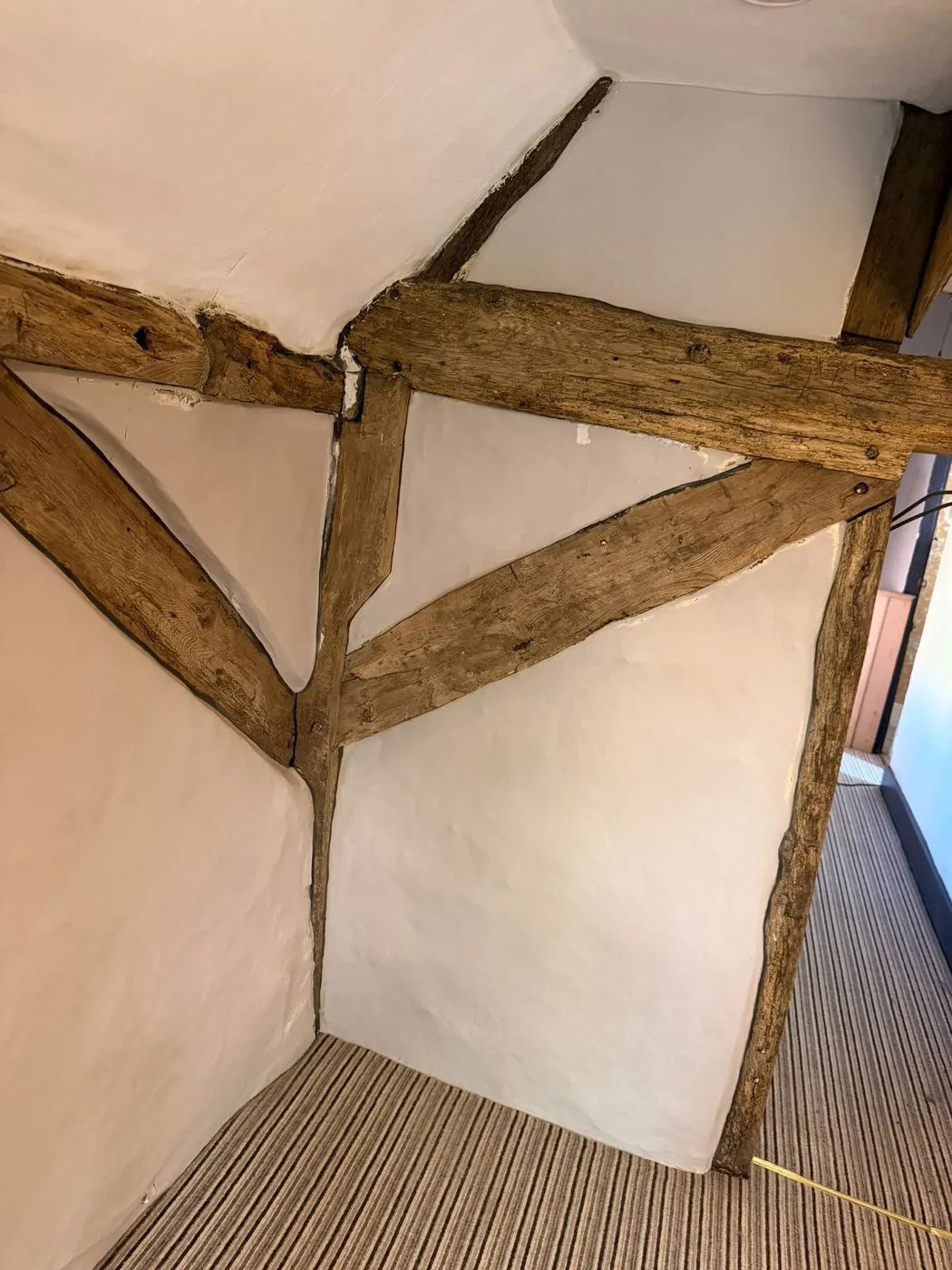 Clean oak beam surface with warm wood tone and original character visible after restoration