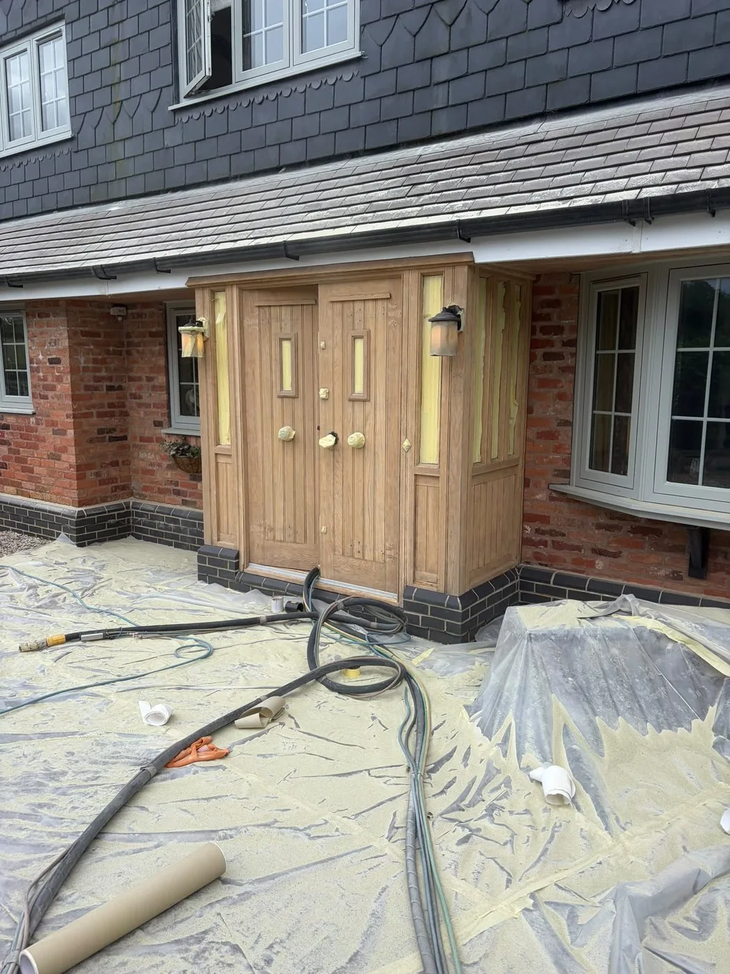 Restored oak porch and double doors with clean pale grain and refreshed detail