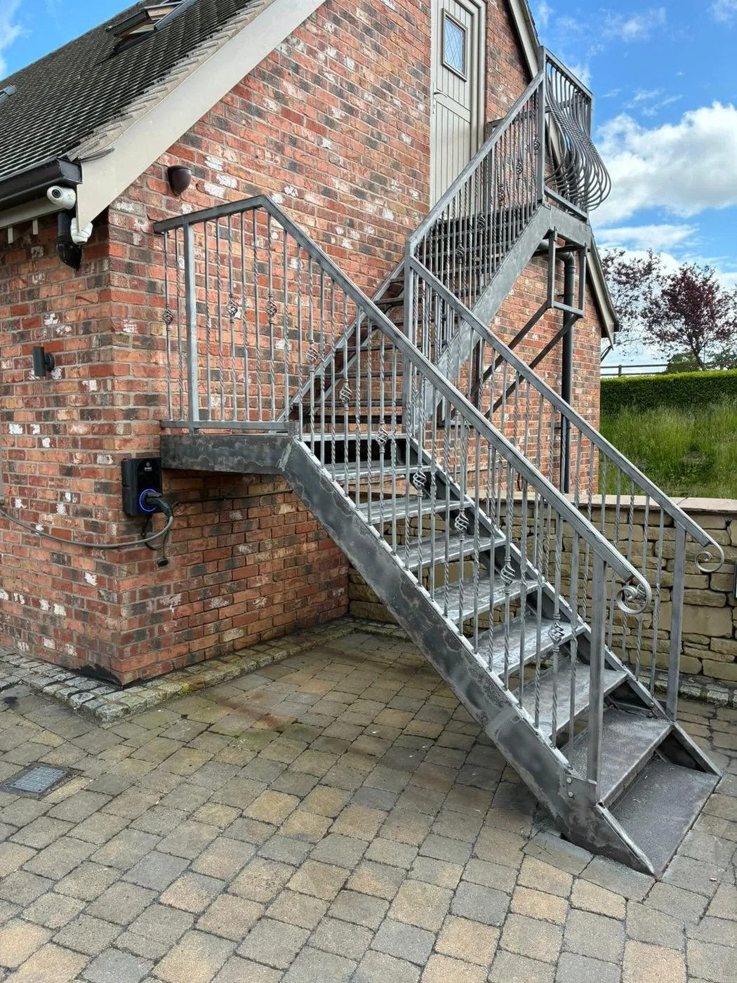 Exterior steel staircase with a clean, uniform prepared surface ready for primer and paint