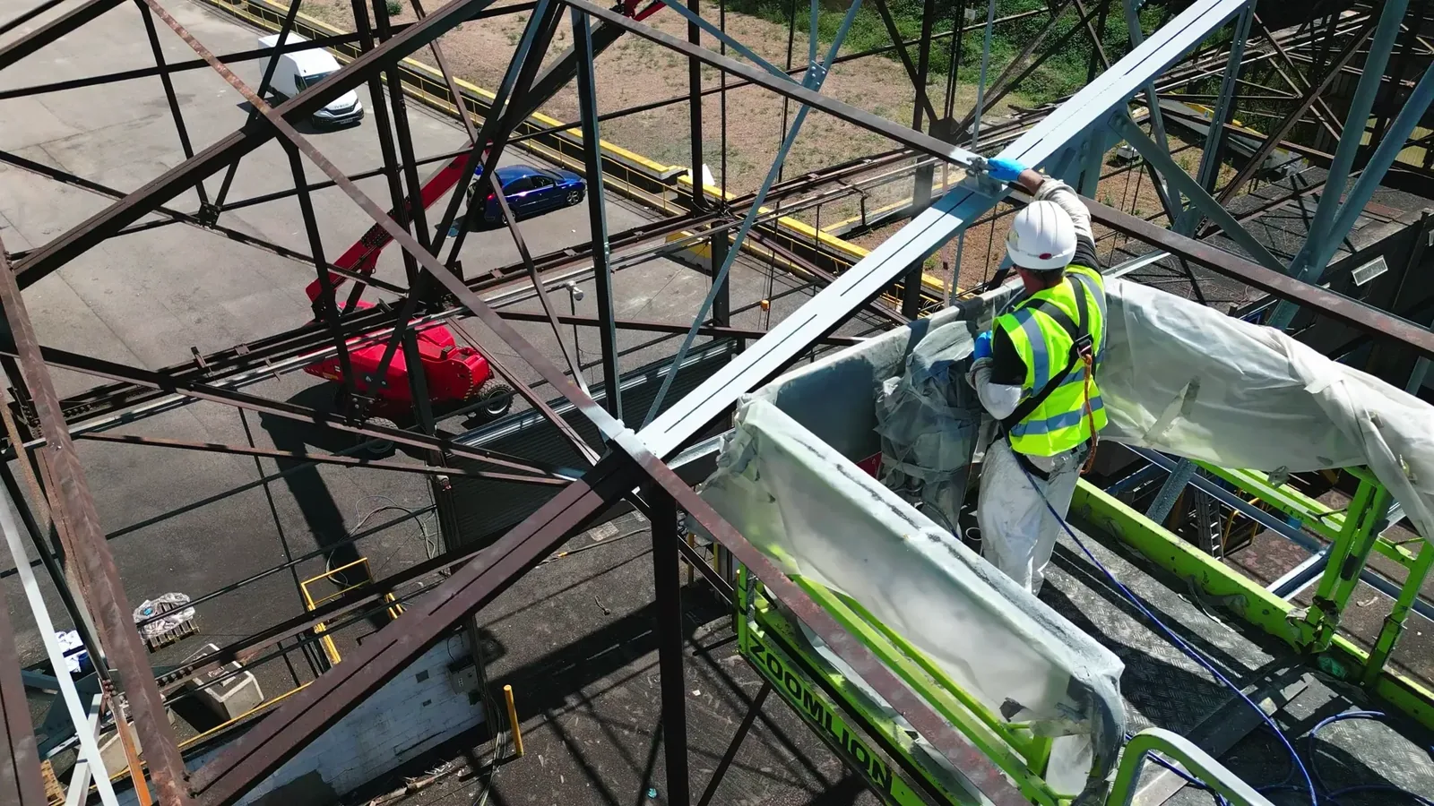 Spray application of protective coating across restored high-level warehouse steelwork