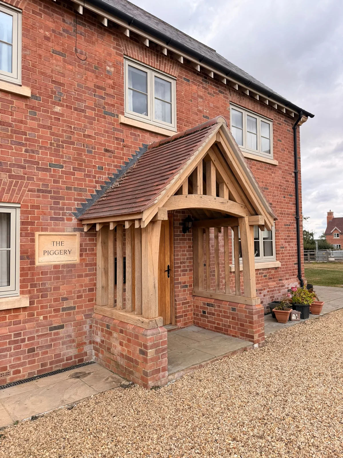 Restored side view of the oak porch showing cleaner posts and braces