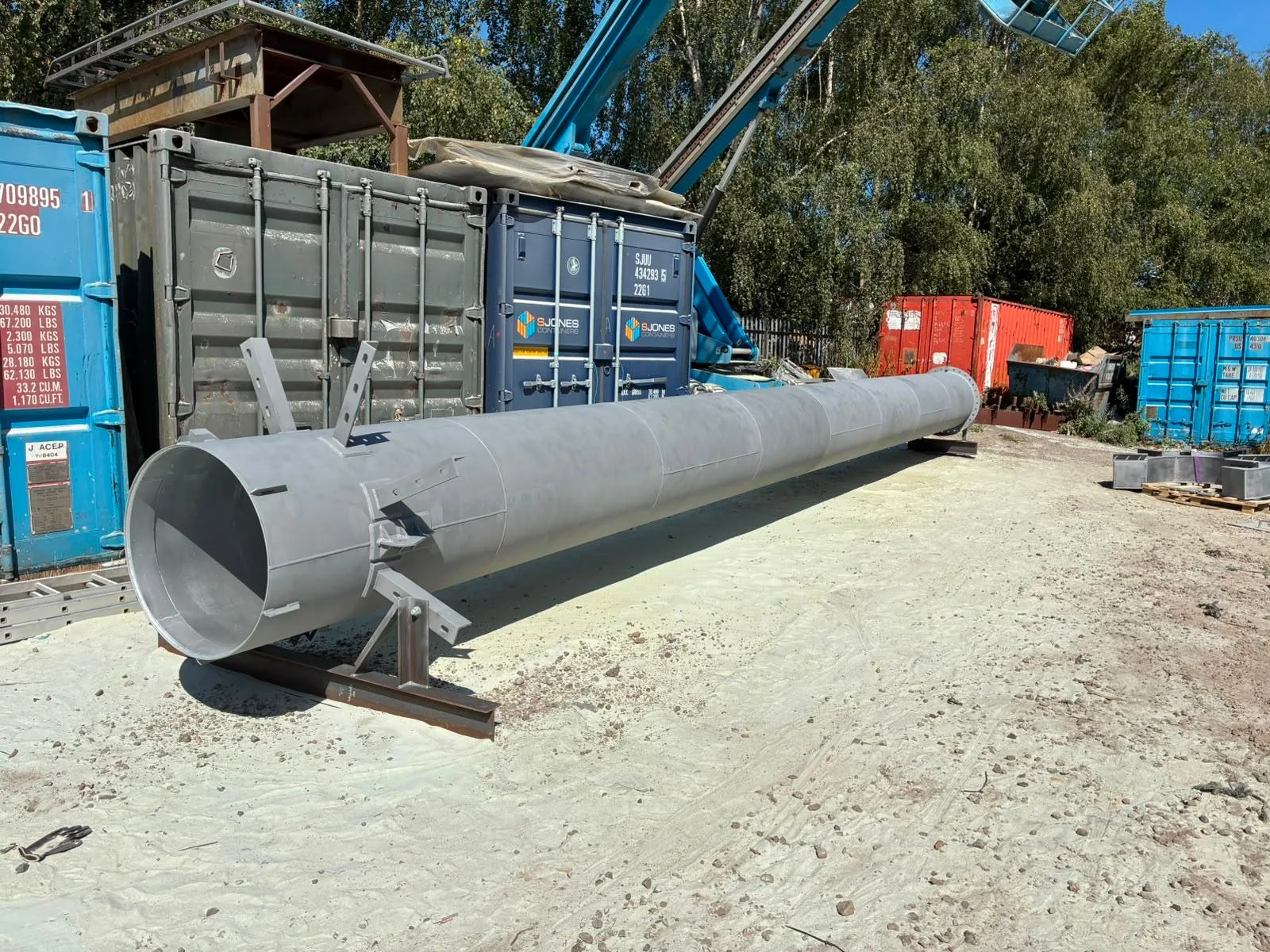 Steel chimney after restoration, showing an even clean metal surface across the body and fabricated components ready for coating.