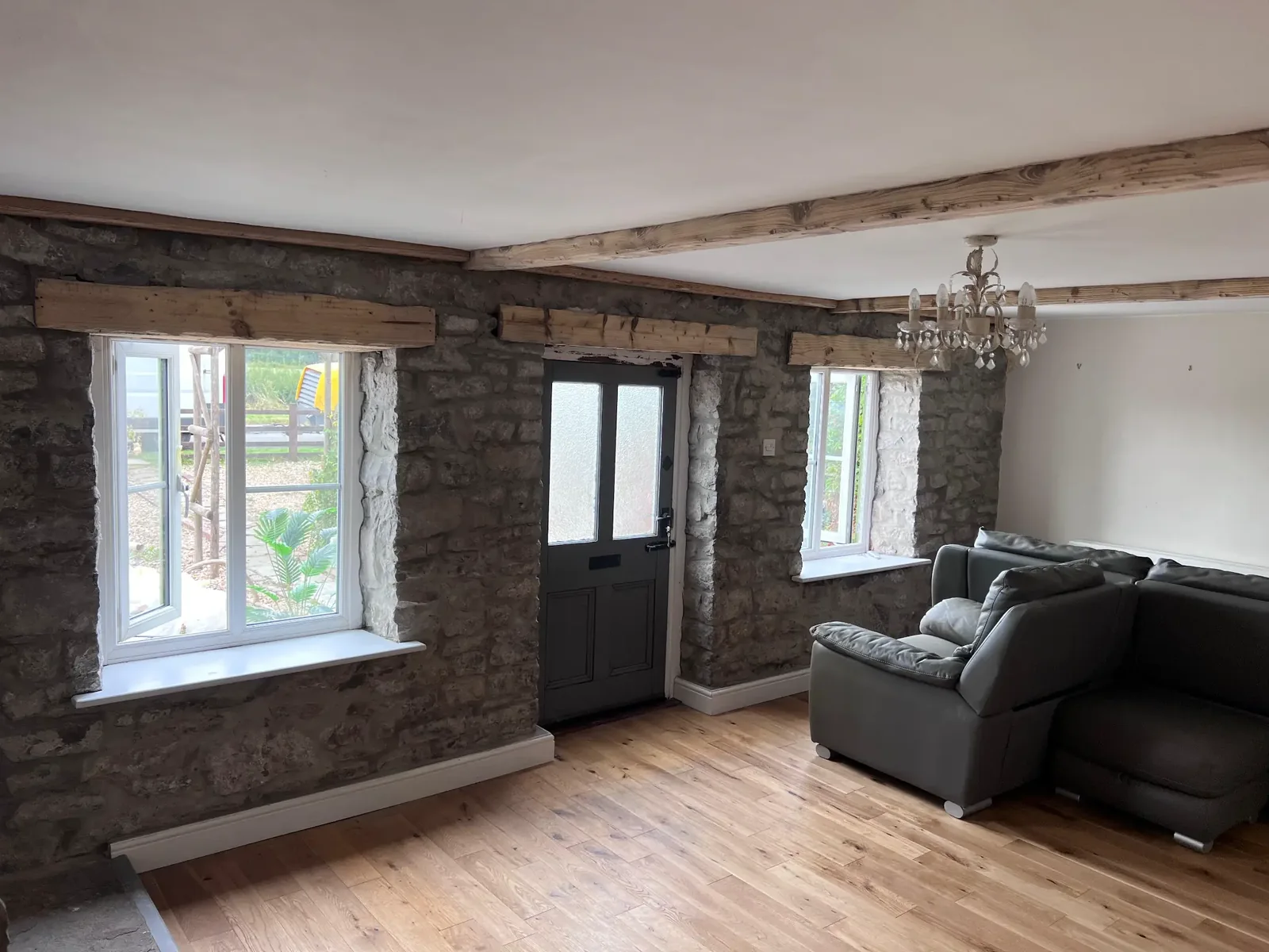 Restored exposed timber beams revealing lighter natural grain