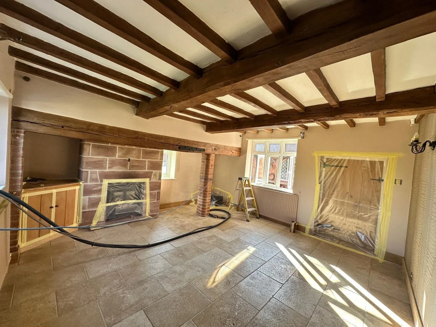 Second oak beam project before restoration with aged dark timber finish in a heritage interior