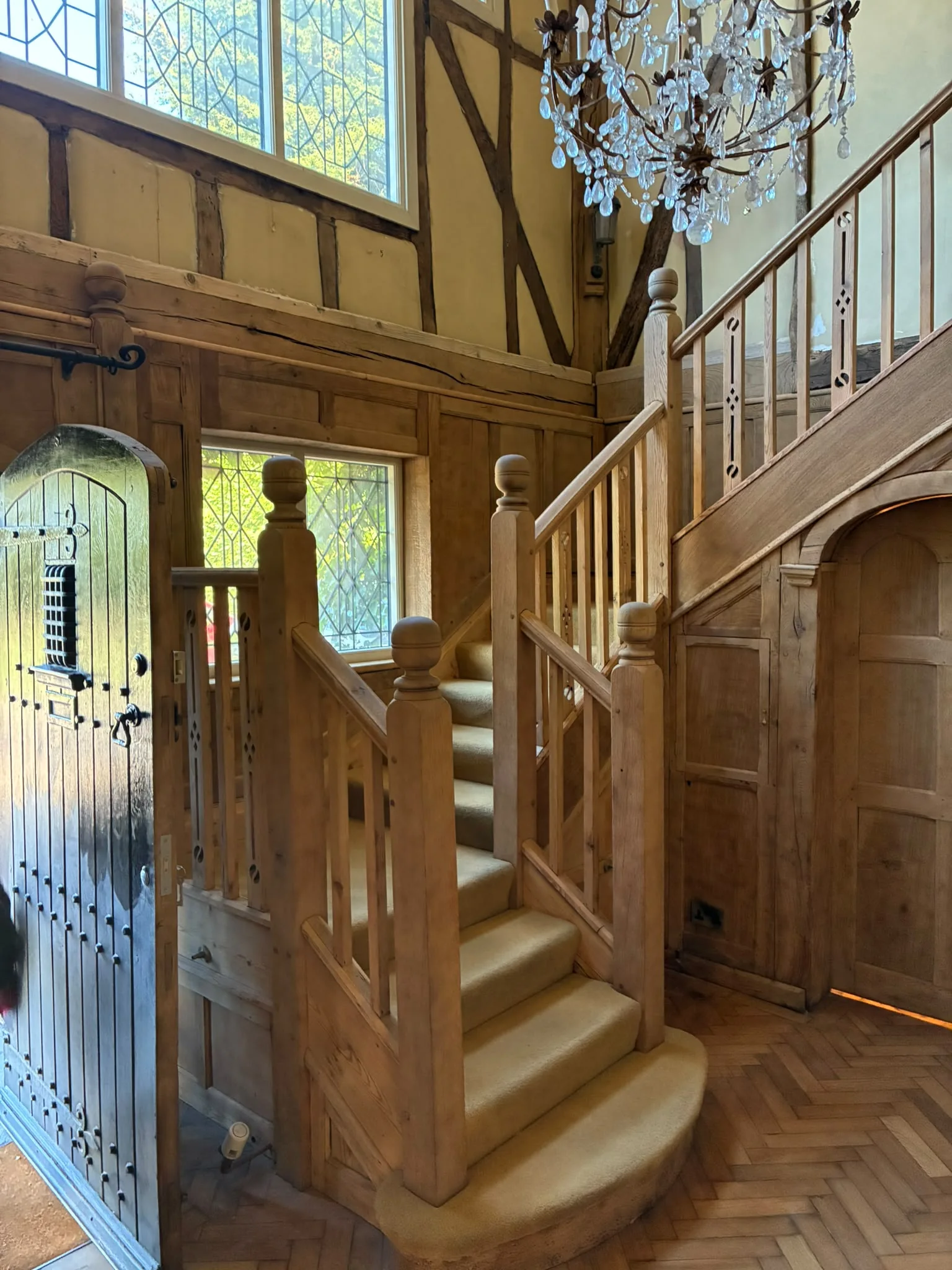 Grand Hall staircase after restoration with lighter natural timber panelling and bright original character