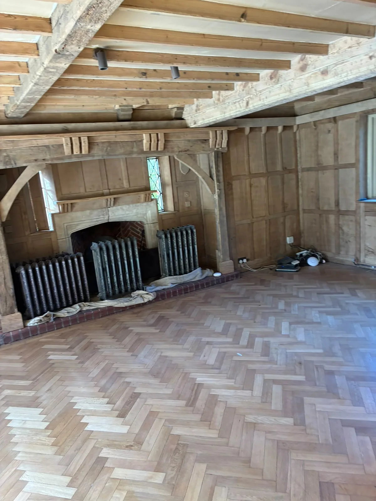Grand Hall living area after restoration with the natural grain of the original timber revealed